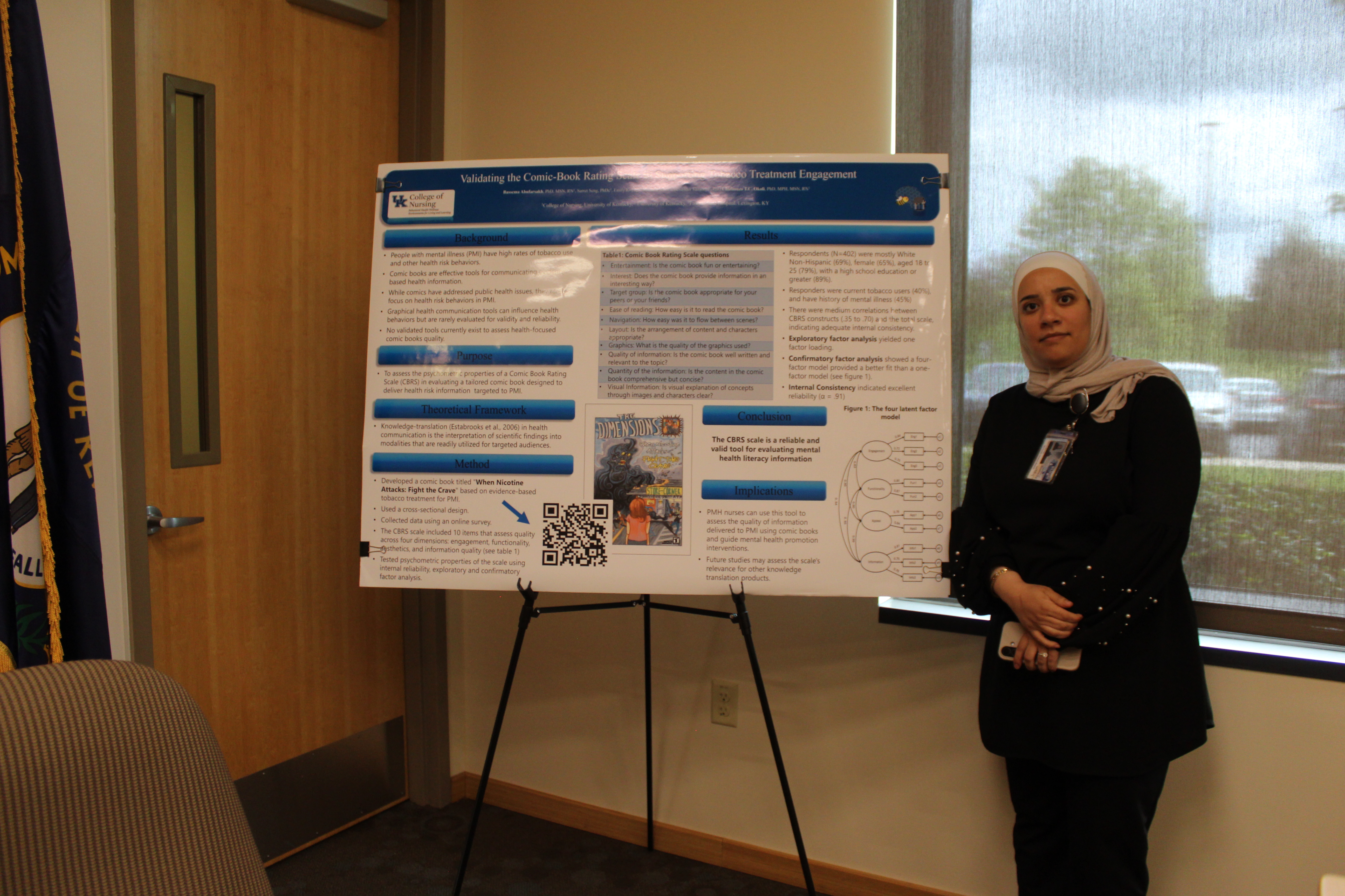 woman in hijab next to large research poster about comic books
