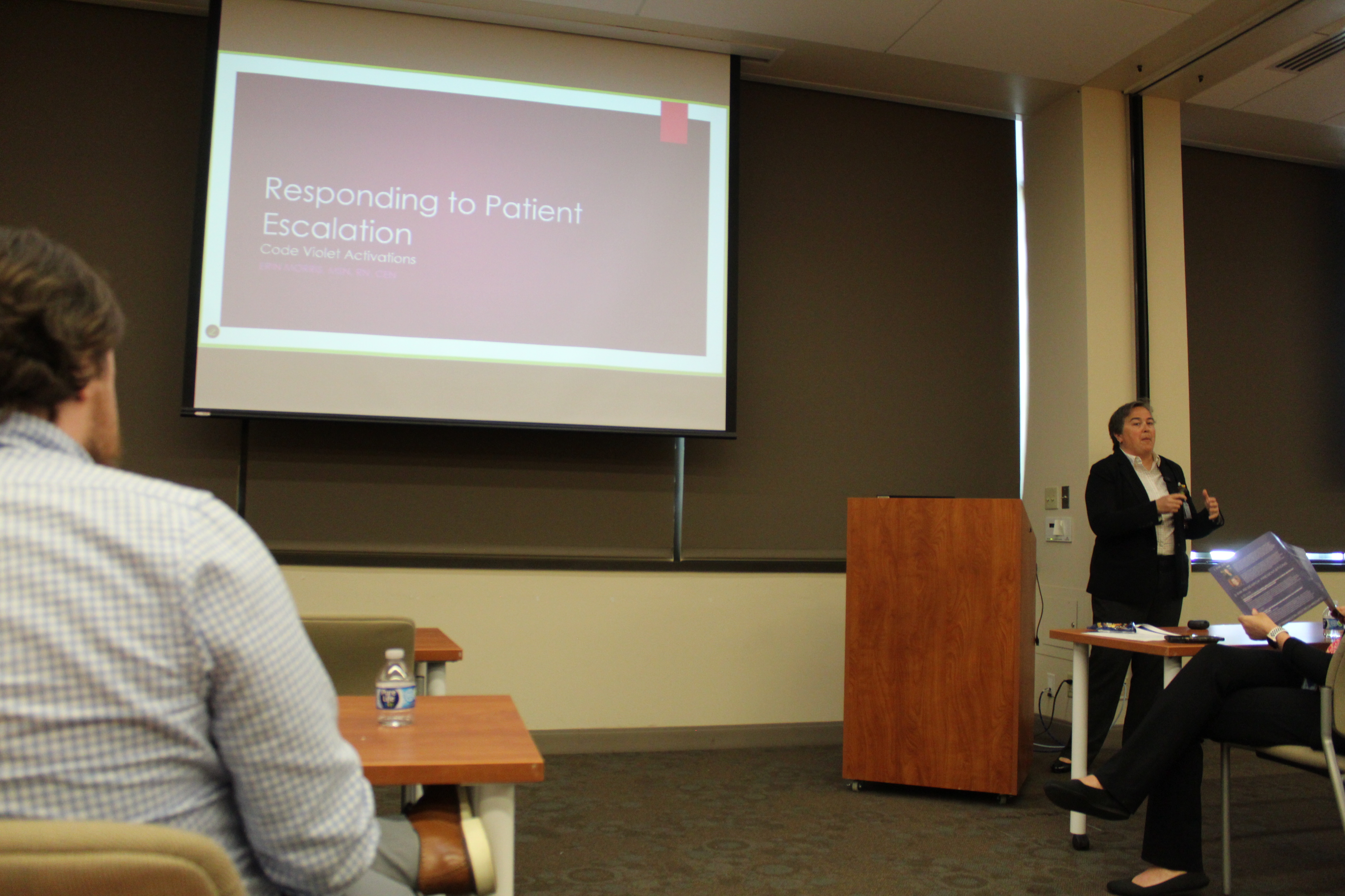 erin morris dressed in blazer presenting powerpoint