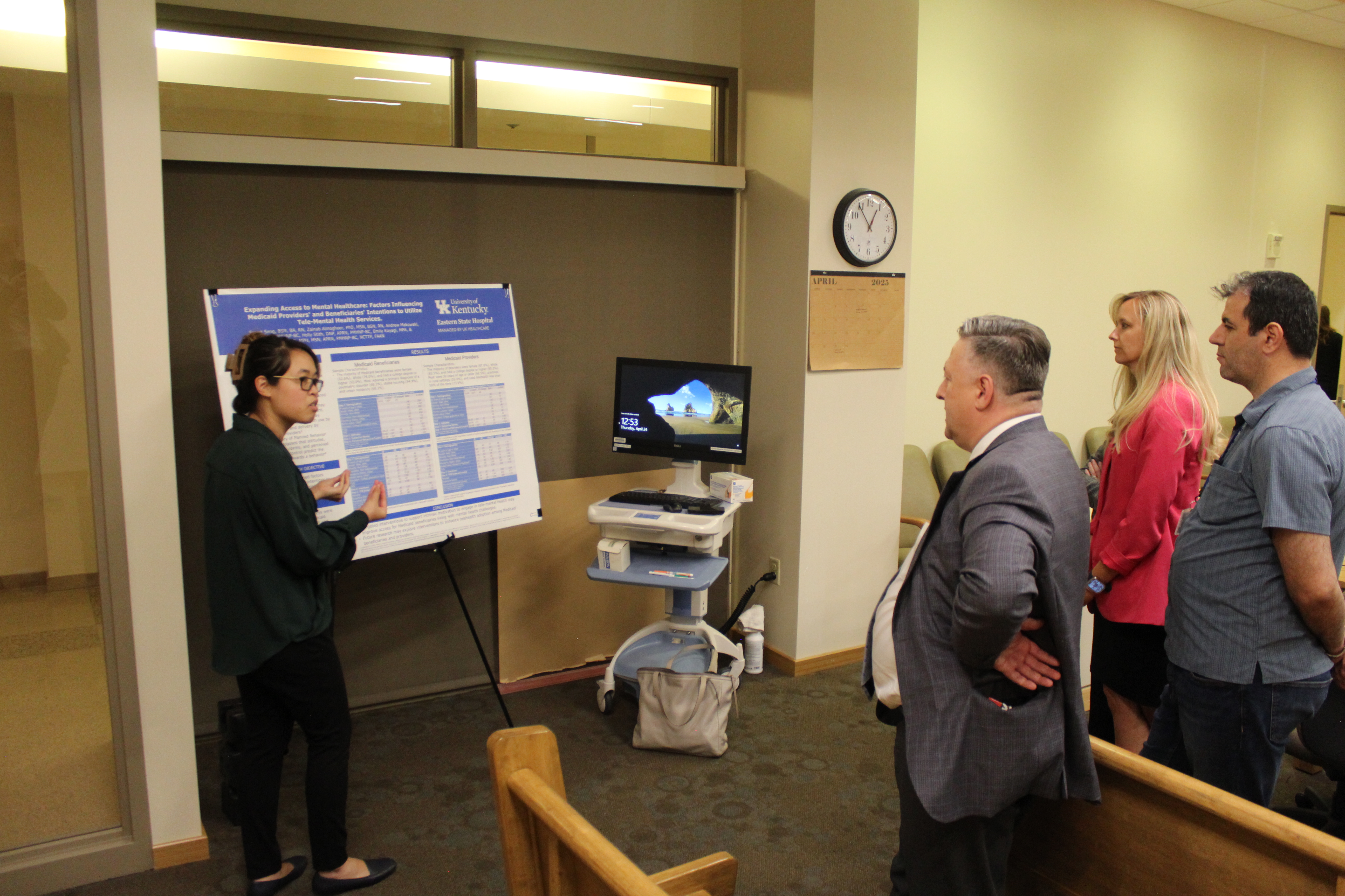 sarret presenting poster to group of people