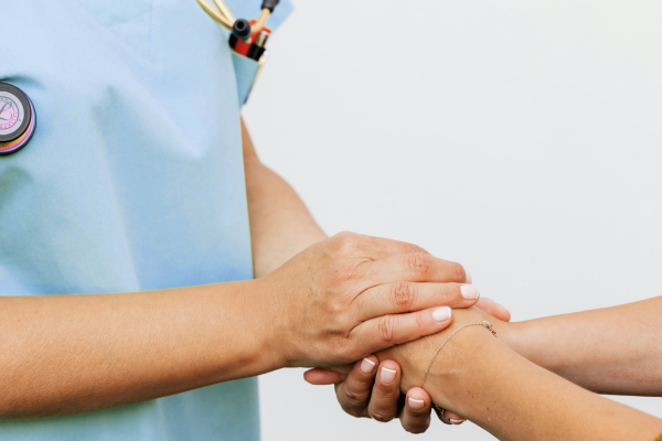 nurse holding patient hand