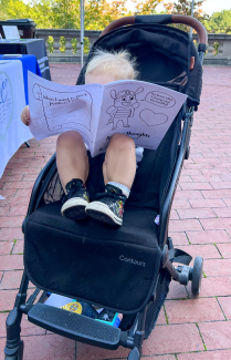 kid in stroller with coloring book