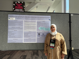 Dr. Abu Farsakh in front of her poster