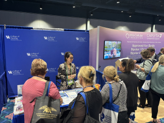 Conference attendees visiting the BH WELL table 