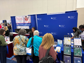 Conference Attendees visiting BH WELL table