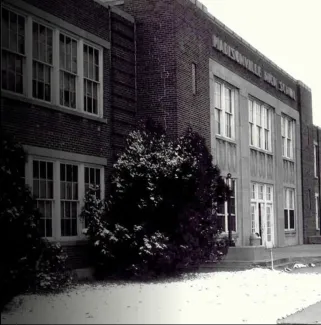 sepia image of brick school building