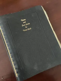 blck journal with "poems and short stories by Portia Beck" inscribed