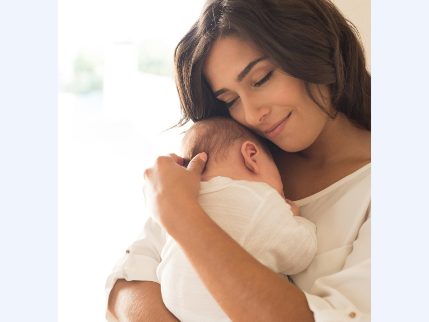 mother holding baby close on chest