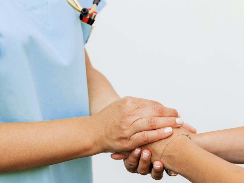 nurse holding patient hand
