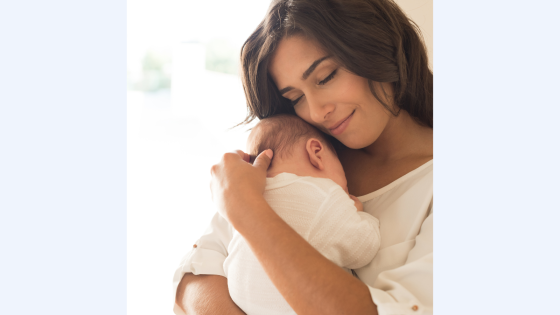 mother holding baby close on chest