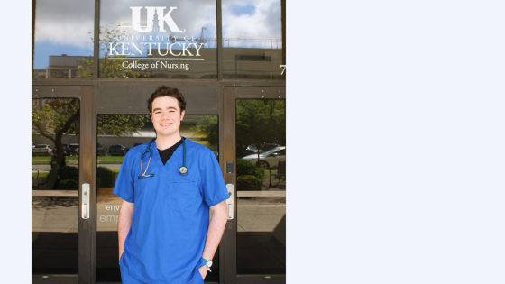 tall white young man in blue scrubs in front of UK college of nursing
