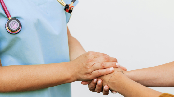 nurse holding patient hand