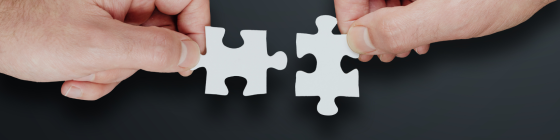 hands putting puzzle together