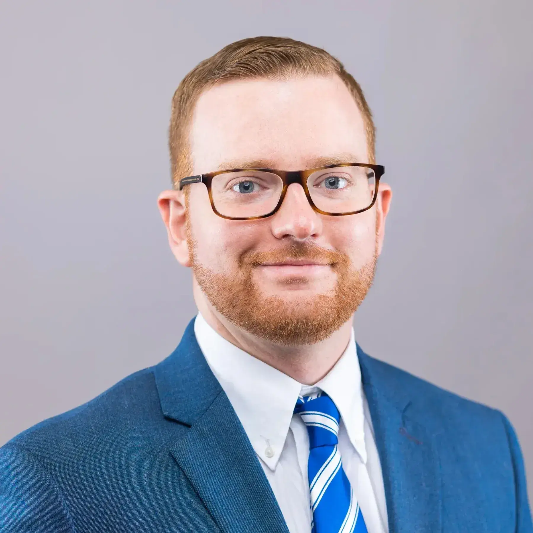 Young Red headed man with glasses  in suit