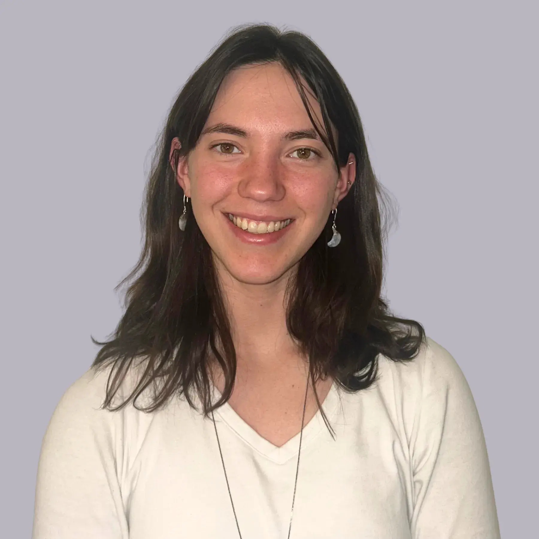 young white woman in white shirt on gray background